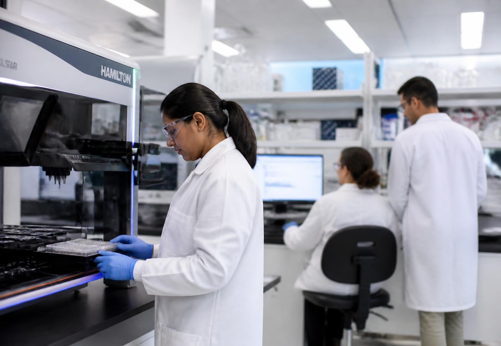 Photograph of a discovery laboratory bench with automated screening equipment, representing the fragment screening and structural biology program